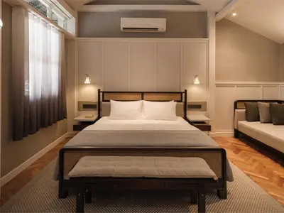 a bedroom with a bed and a couch at Noordin Mews in George Town