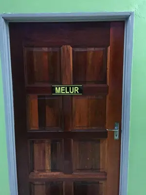 a door with a sign that says melvin on it at Bunga Raya Guest House BALING in Baling