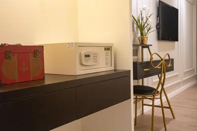 a microwave sitting on top of a counter with a chair at White Mansion Penang in George Town