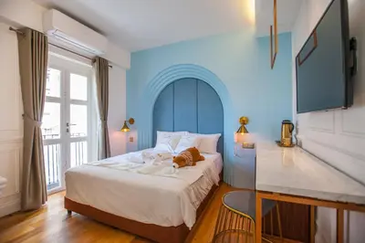 a bedroom with a bed with a teddy bear on it at White Mansion Penang in George Town