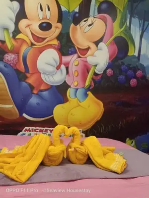 a mickey mouse figurine on a table with bananas at WindMill SunRise PaddyView Homestay in Sekincan