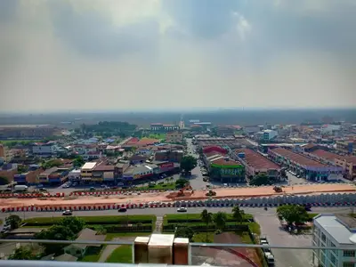 an overhead view of a city with buildings and a street at WindMill SunRise PaddyView Homestay in Sekincan