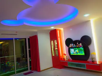 a room with a tv and a blue ceiling at WindMill SunRise PaddyView Homestay in Sekincan