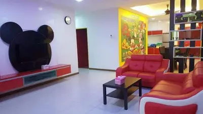a living room with two chairs and a tv at WindMill SunRise PaddyView Homestay in Sekincan