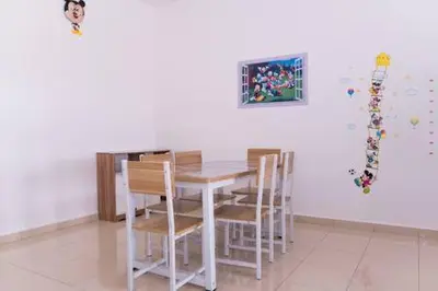 a dining room with a white table and chairs at Qstay Sitiawan Townhouse (Minnie Dreams) - \u7c73\u59ae\u68a6 in Sitiawan