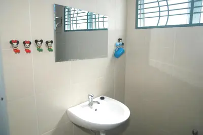a white bathroom with a sink and a mirror at Qstay Sitiawan Townhouse (Minnie Dreams) - \u7c73\u59ae\u68a6 in Sitiawan