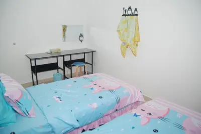 a bedroom with a bed with hello kitty sheets at Qstay Sitiawan Townhouse (Totoro Dreams) - \u68a6\u89c1\u9f99\u732b in Sitiawan