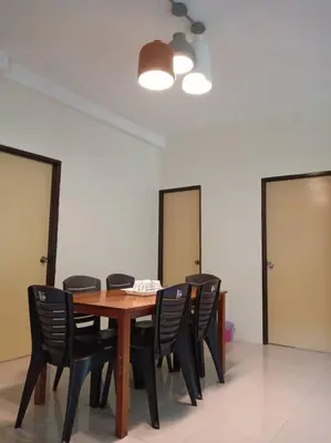 a wooden table with black chairs in a room at Mag Homestay at Crown Imperial Court, Brinchang in Cameron Highlands