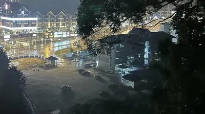 a night view of a city with buildings and a street at Mag Homestay at Crown Imperial Court, Brinchang in Cameron Highlands
