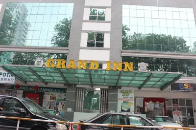 a grand inn sign on the front of a building at Grand Inn Hotel - Macalister Road in George Town