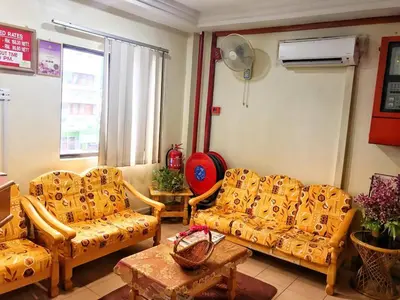 a living room with two couches and a table at Hotel Sri Raub in Raub