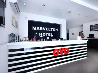 a lobby of a marriott hotel with a sign on the wall at Hotel O Marvelton Hotel in Butterworth