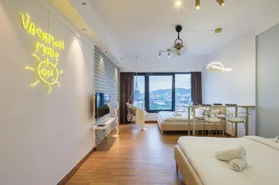 a hotel room with two beds and a dining area at Tropicana 218 Macalister in George Town