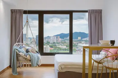 a bedroom with a swing and a large window at Tropicana 218 Macalister in George Town