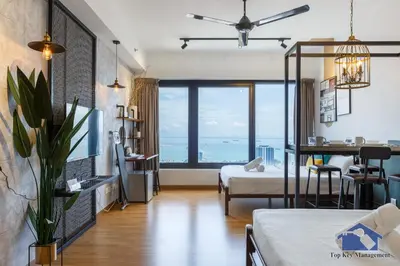 a bedroom with a bed and a large window at Tropicana 218 Macalister in George Town