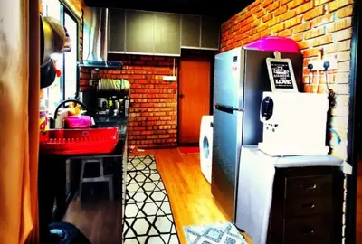 a kitchen with a refrigerator and a brick wall at Petak Padin Cottage by The Pool, Kepala Batas Penang in Kepala Batas