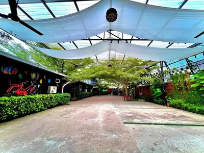 a white canopy over a walkway in a garden at Petak Padin Cottage by The Pool, Kepala Batas Penang in Kepala Batas