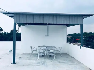 a table and chairs sitting under a pavilion at LunaStay (Shared Common Area) in Lunas