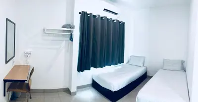 a small room with two beds and a desk at LunaStay (Shared Common Area) in Lunas