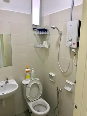 a bathroom with a shower and a toilet and a sink at Spice Tunas 3B2B House in Bayan Lepas