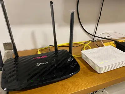 a black router sitting on top of a desk at Spice Tunas 3B2B House in Bayan Lepas