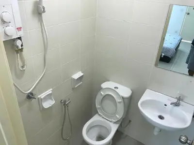 a bathroom with a shower and a toilet and a sink at Spice Tunas 3B2B House in Bayan Lepas