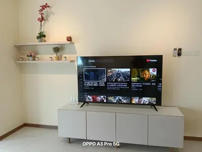 a flat screen tv on a wall in a room at Sekinchan HighView Penthouse 15pax 5R5B \u9876\u5c42\u516c\u5bd3 \u770b\u6d77 \u770b\u7a3b\u7530\u666f in Sekincan