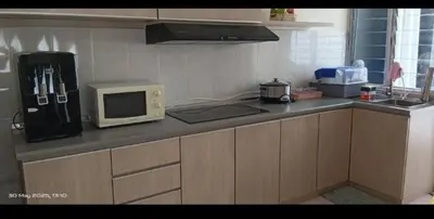 a kitchen with a counter top with a microwave at Sekinchan HighView Penthouse 15pax 5R5B \u9876\u5c42\u516c\u5bd3 \u770b\u6d77 \u770b\u7a3b\u7530\u666f in Sekincan