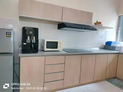a kitchen with a counter with a microwave and a refrigerator at Sekinchan HighView Penthouse 15pax 5R5B \u9876\u5c42\u516c\u5bd3 \u770b\u6d77 \u770b\u7a3b\u7530\u666f in Sekincan