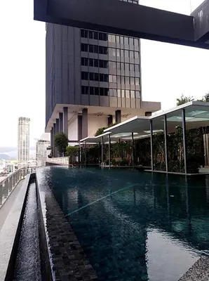 a swimming pool in front of a building at Georgetown City View Condo Tropicana 218 Macalister in George Town