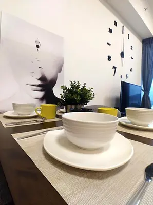 a table with white bowls on top of it at Georgetown City View Condo Tropicana 218 Macalister in George Town