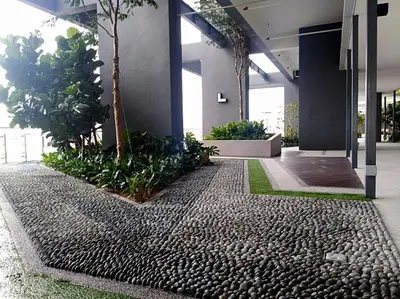 an office lobby with a gravel path and trees at Georgetown City View Condo Tropicana 218 Macalister in George Town
