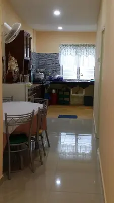 a kitchen with a table and chairs and a dining room at IsMa Lumut Homestay in Lumut