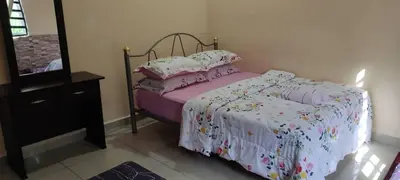 a bedroom with a bed and a dresser and a mirror at IsMa Lumut Homestay in Lumut