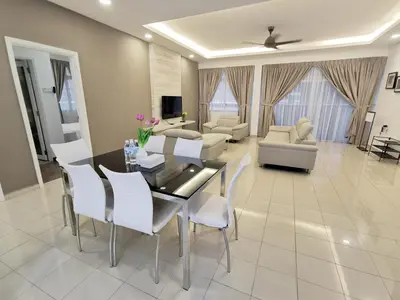 a dining room and living room with a table and chairs at 3 Concordia @ Gurney in George Town