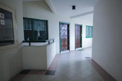 a hallway with windows and a tv on a wall at Fun Apartment @ Equatorial Hill Resort in Cameron Highlands
