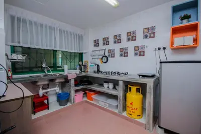 a kitchen with a sink and a refrigerator at Fun Apartment @ Equatorial Hill Resort in Cameron Highlands