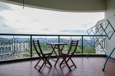a table and two chairs on a balcony with a view at Fun Apartment @ Equatorial Hill Resort in Cameron Highlands