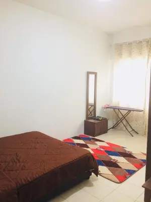 a bedroom with a bed and a mirror on the floor at Ainul MarDhiah @ Cameron Highland (muslim stay) in Cameron Highlands