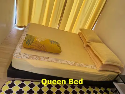 a yellow bed with a yellow pillow on top of it at Purple Cube at Lumut Cube Homestay Kontena in Lumut