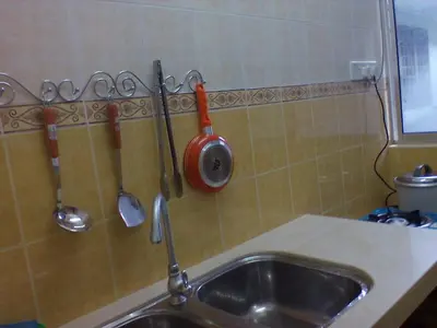 a kitchen sink with utensils hanging on a wall at D'Puncak Arabella Muslim Homestay in Cameron Highlands