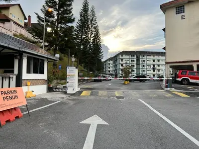 an empty parking lot with an arrow on the street at D'Puncak Arabella Muslim Homestay in Cameron Highlands