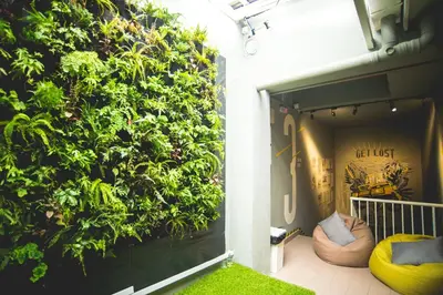 a large green wall on the side of a building at Traveller Bunker Hostel 1 in Cameron Highlands
