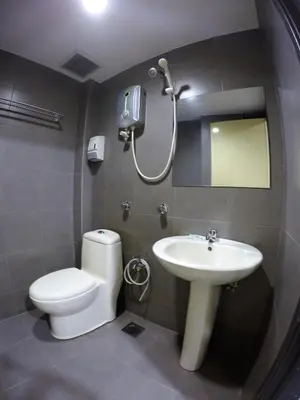 a bathroom with a toilet and a sink and a shower at Hotel Bestari in Kuala Lipis