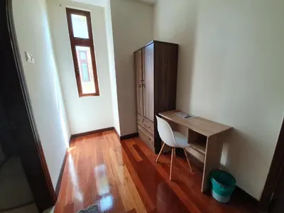 a room with a desk and a cabinet and a chair at Eden Cosy Living in Batu Ferringhi