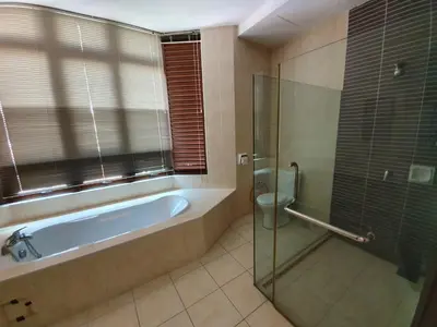a bathroom with a tub and a shower and a toilet at Eden Cosy Living in Batu Ferringhi