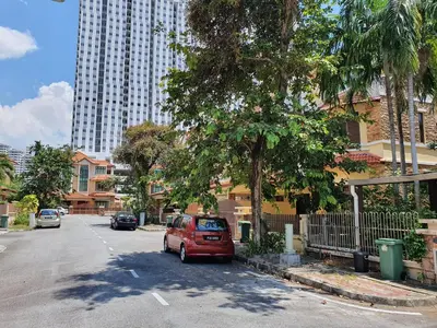a red van parked in a parking lot in a city at Eden Cosy Living in Batu Ferringhi