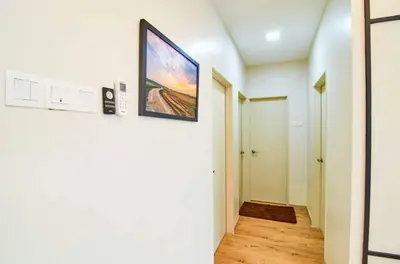 a hallway with a painting hanging on a wall at Sekinchan PaddyView Homestay \u9ad8\u697c \u770b\u7a3b\u7530 \u9633\u53f0\u6c11\u5bbf in Sekincan