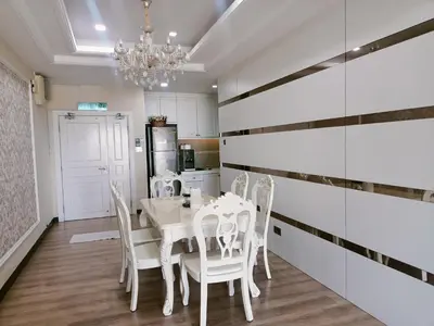a dining room with a white table and chairs at Sekinchan PaddyView Homestay \u9ad8\u697c \u770b\u7a3b\u7530 \u9633\u53f0\u6c11\u5bbf in Sekincan