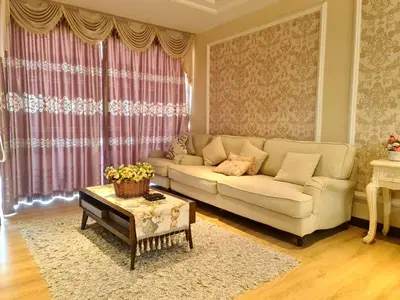 a living room with a white couch and a table at Sekinchan PaddyView Homestay \u9ad8\u697c \u770b\u7a3b\u7530 \u9633\u53f0\u6c11\u5bbf in Sekincan